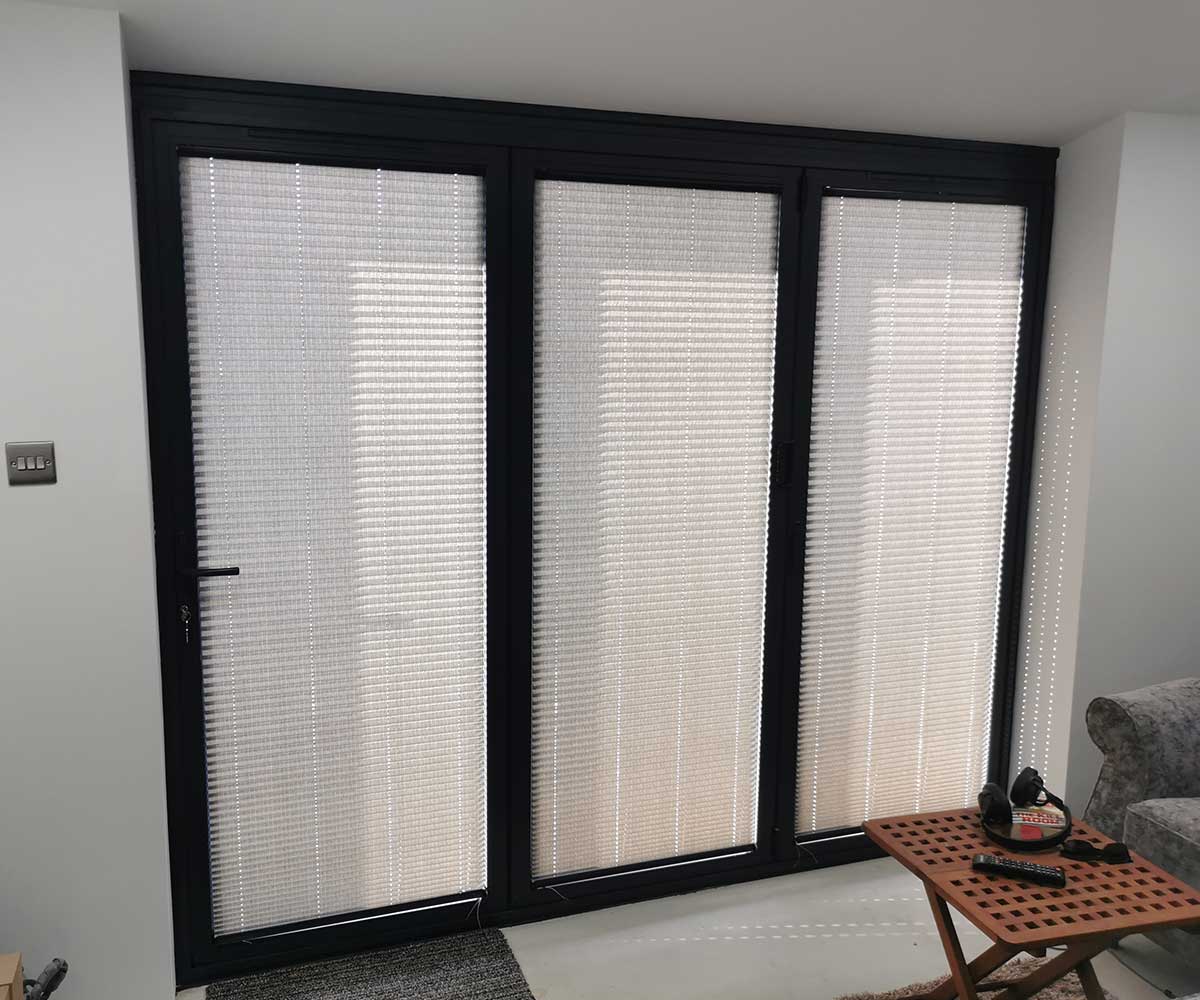 Intu micro pleated blinds fitted within bifold door frames
