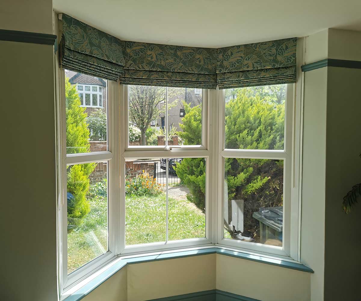 Made-to-measure Roman blinds fitted to a bay window